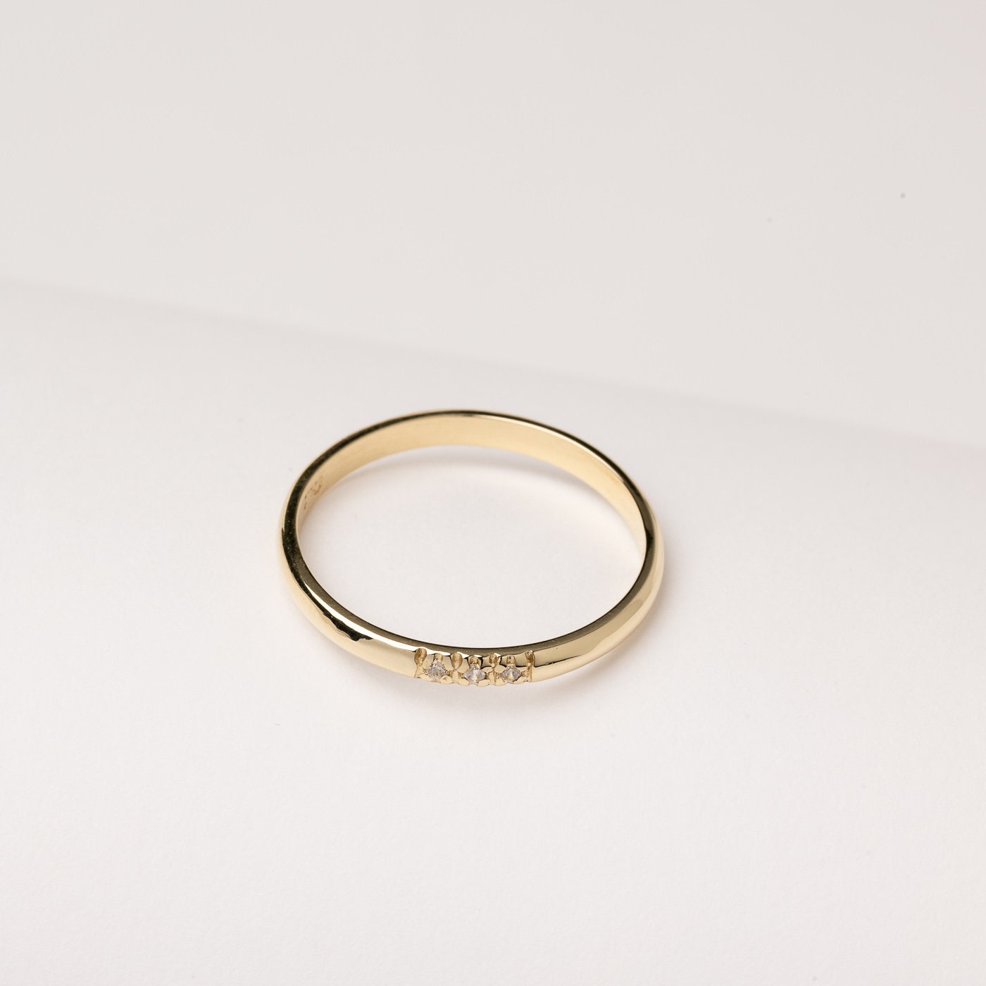 A women's diamond band ring crafted in 14k solid gold.