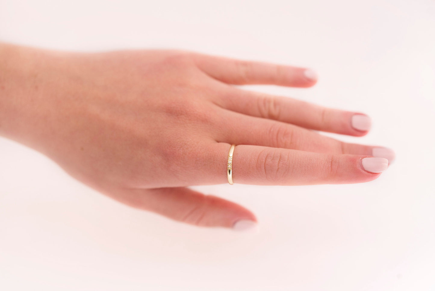 A women's diamond band ring crafted in 14k solid gold.