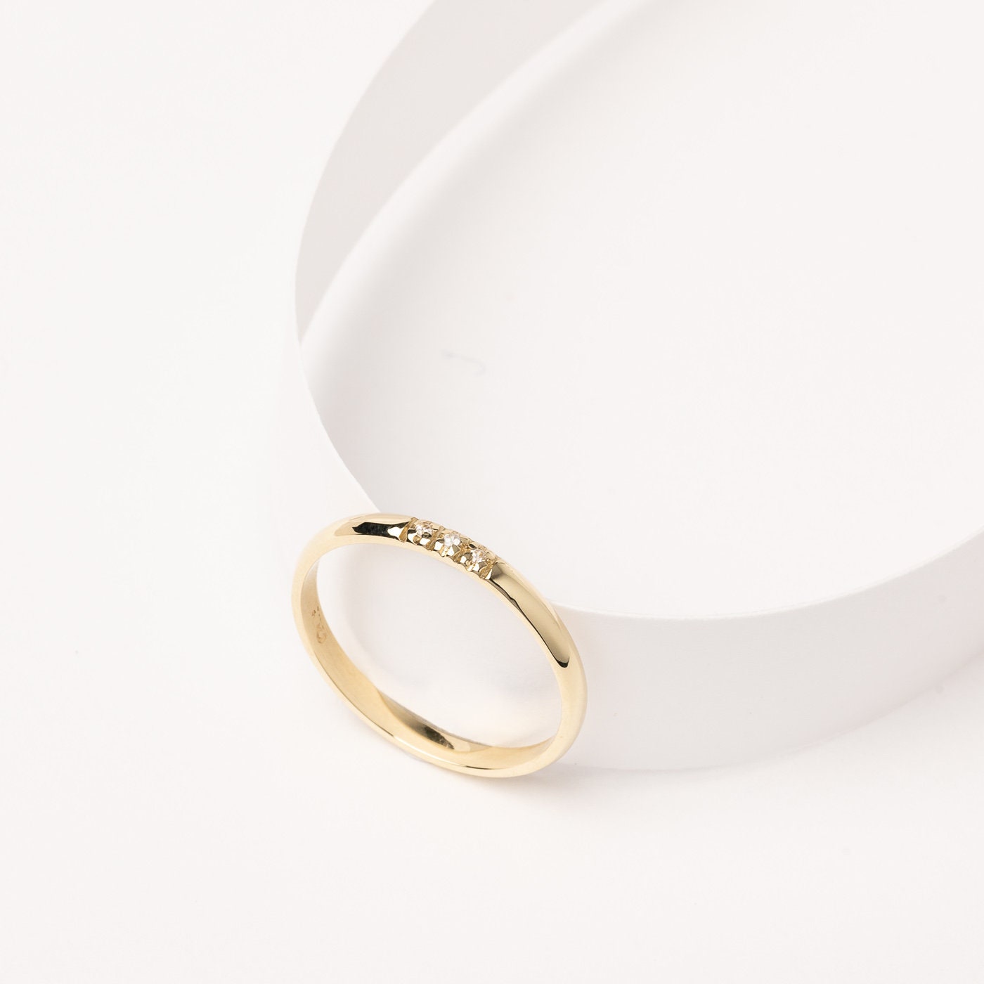 A women's diamond band ring crafted in 14k solid gold.