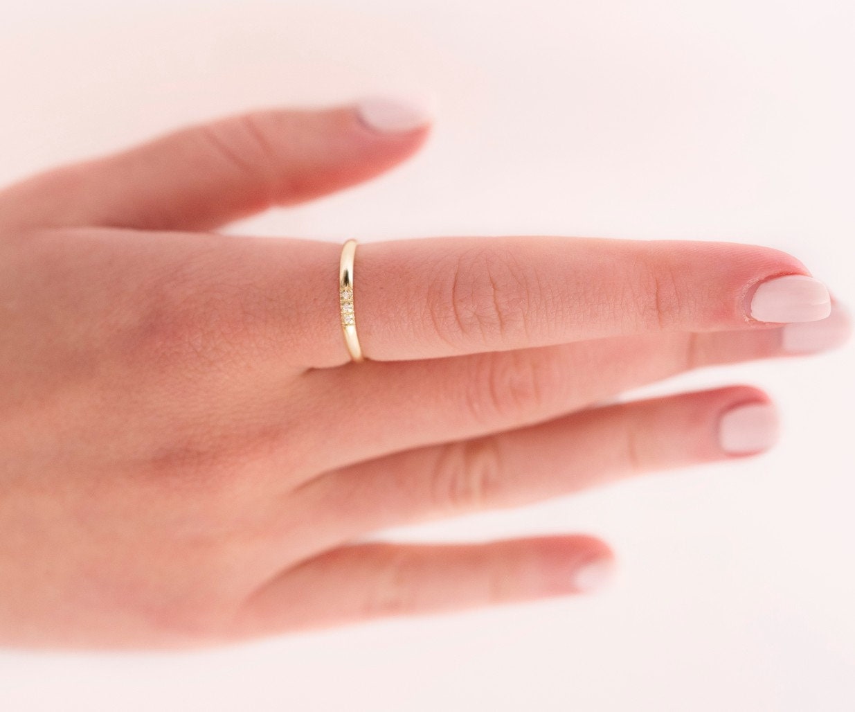 A women's diamond band ring crafted in 14k solid gold.