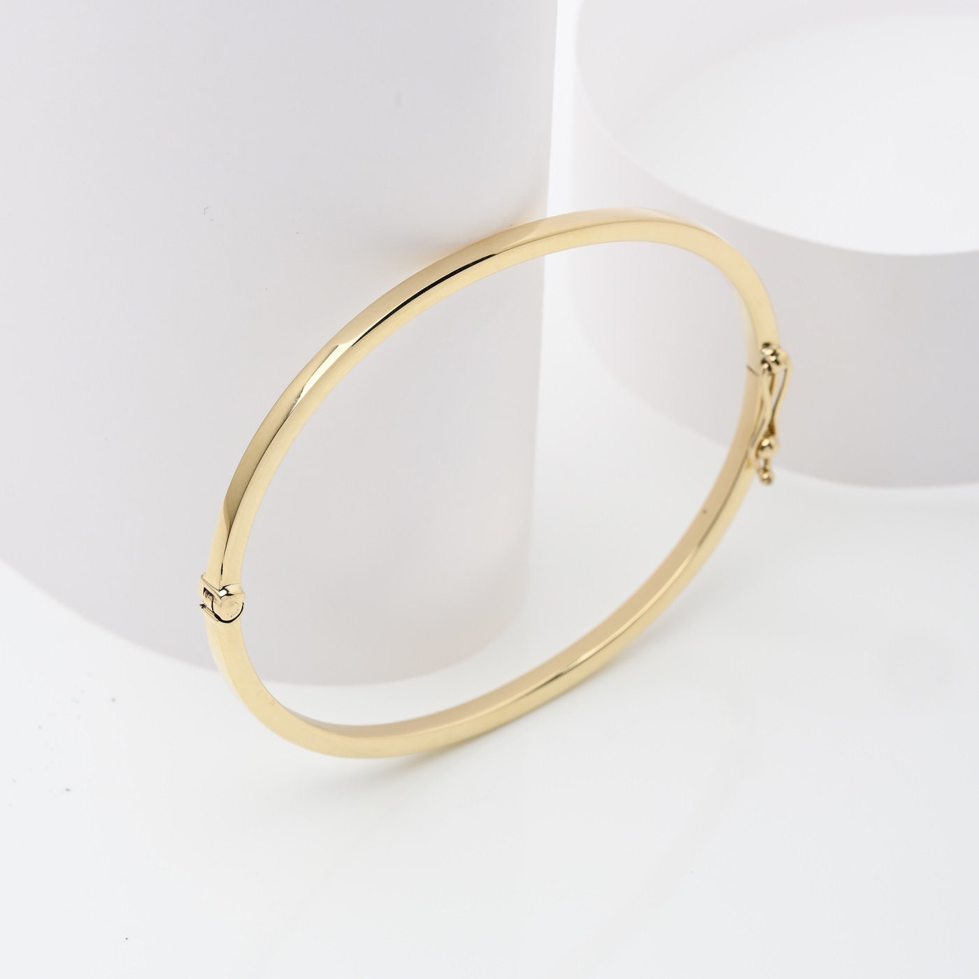 A 2.50mm bangle bracelet crafted in 14k gold, designed for women.
