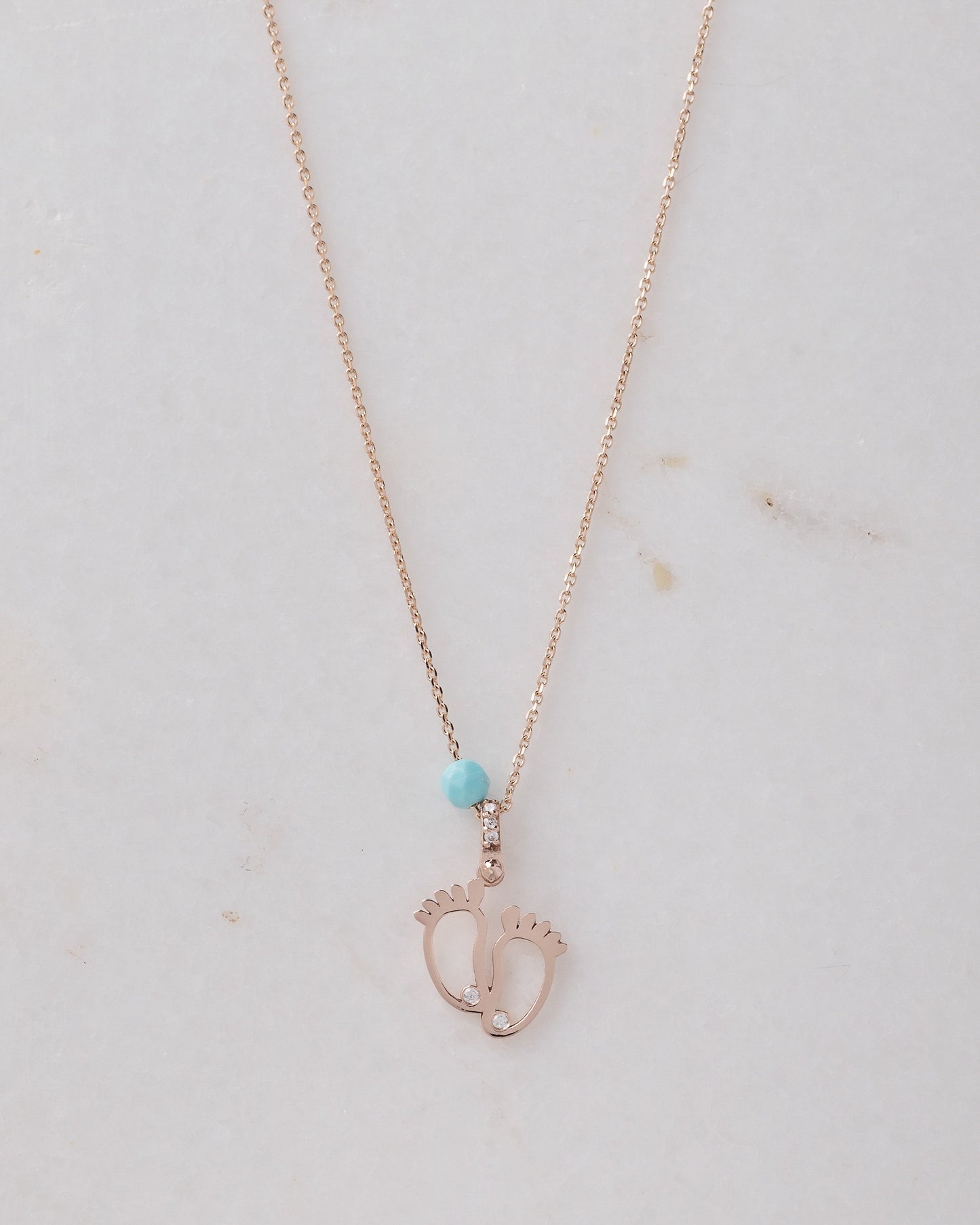 baby footprint necklace in 14k gold with cubic zirconia and turquoise stone