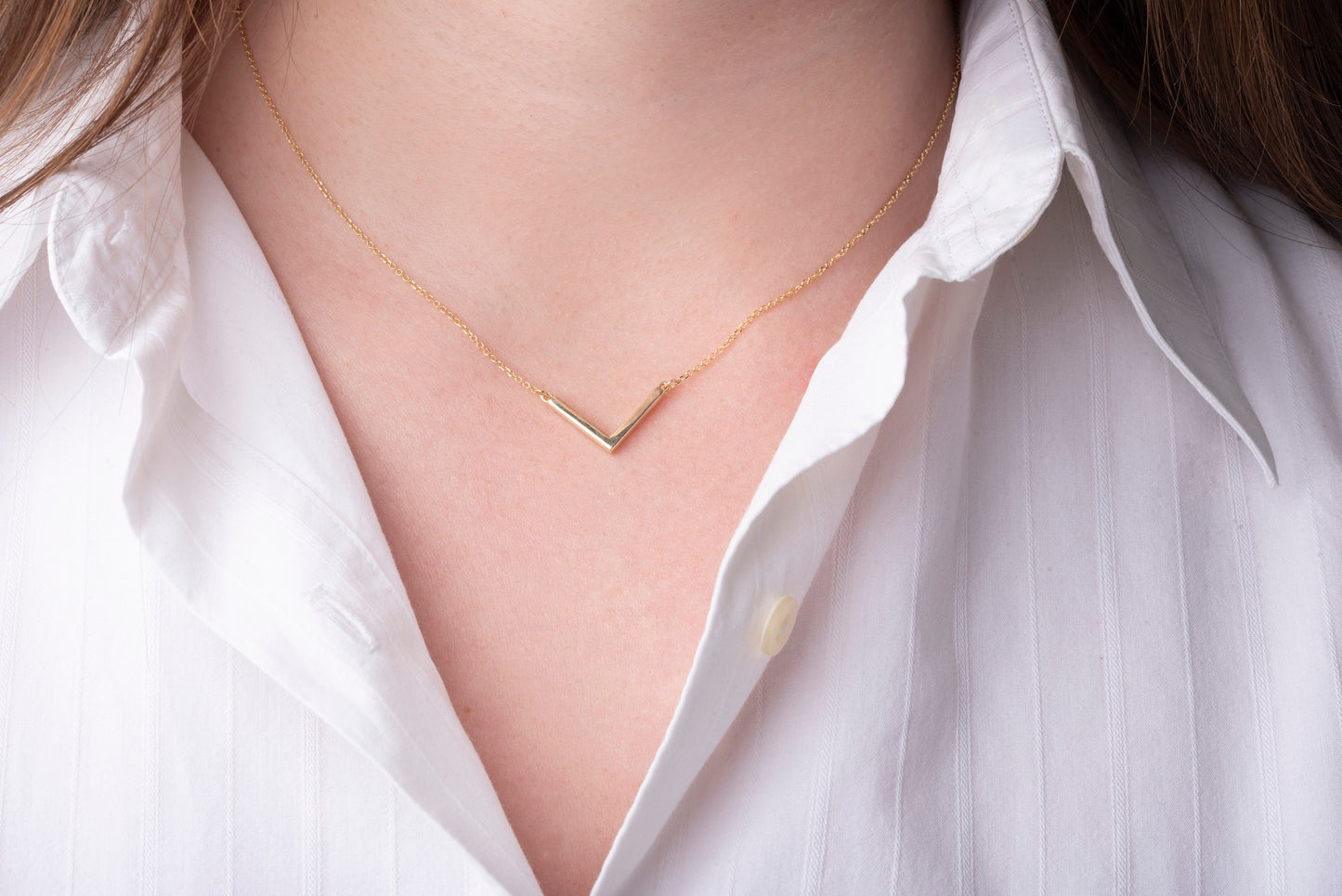 14k gold V shaped necklace for women worn by a model