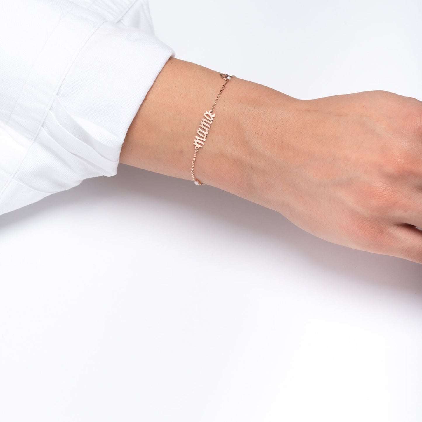 mama 14k gold bracelet with pearls and a small heart worn by a model