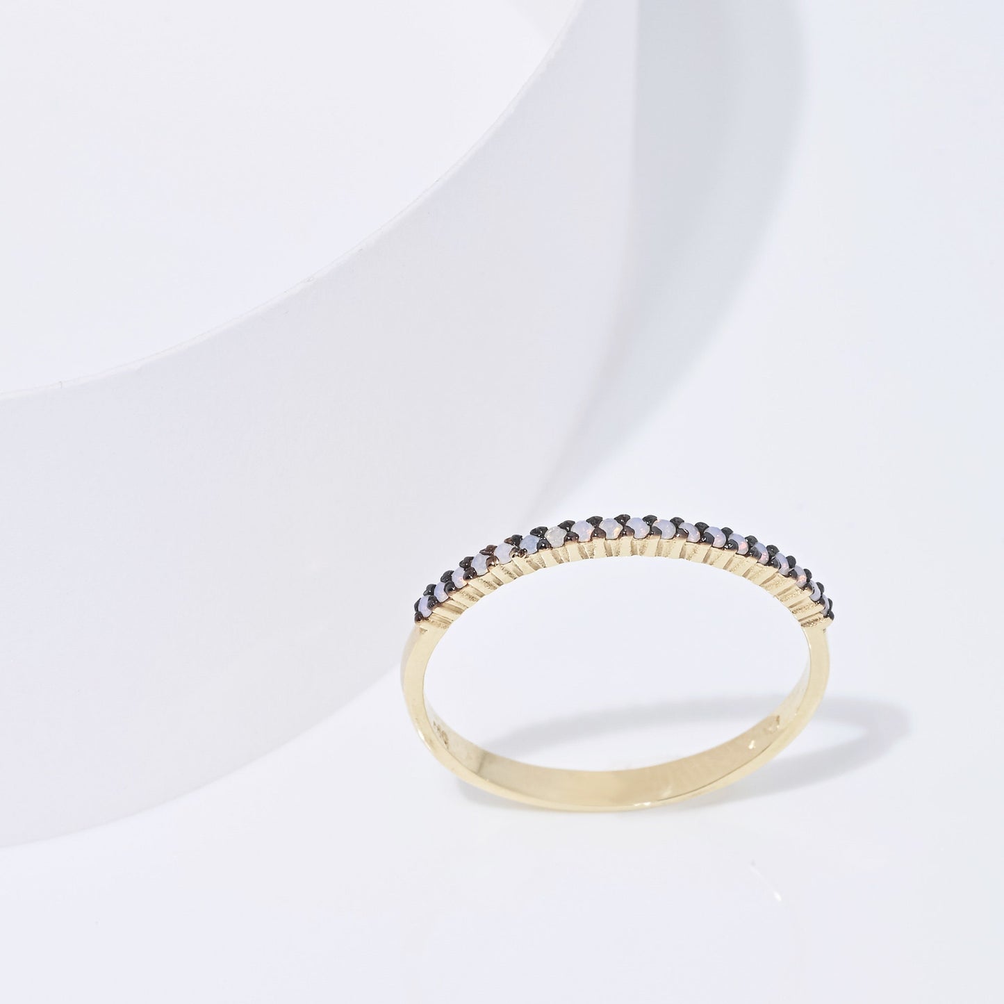 A delicate Opal ring set in 14k gold with a prong setting, designed for women.