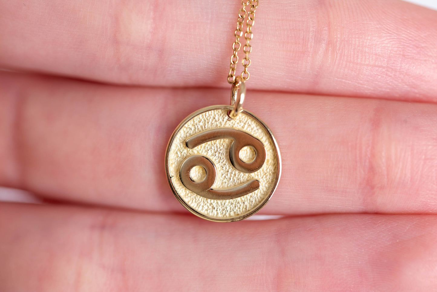 A Zodiac necklace for women, crafted in 14k gold, featuring complimentary engraving on the reverse side.