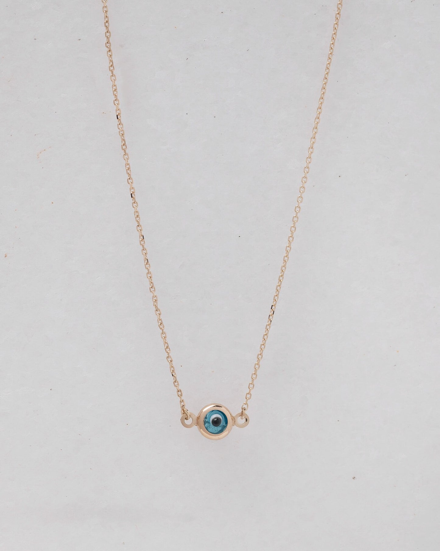 Murano glass double-sided evil eye necklace in 14k gold.