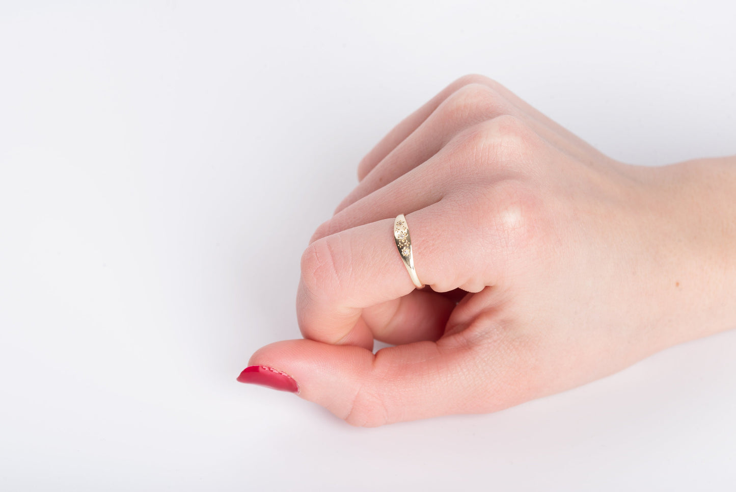 Handcrafted Starburst Ring in 14k gold, embellished with cubic zirconia stones and featuring four engraved stars.