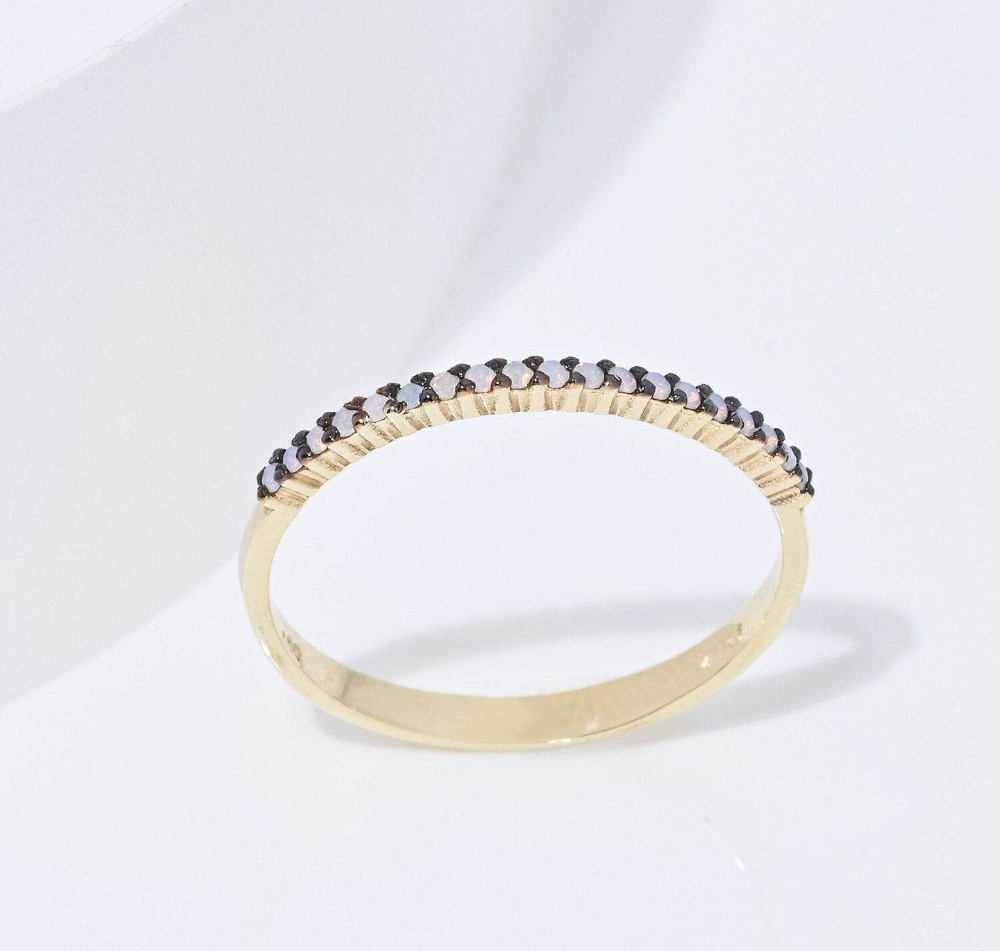 A delicate Opal ring set in 14k gold with a prong setting, designed for women.