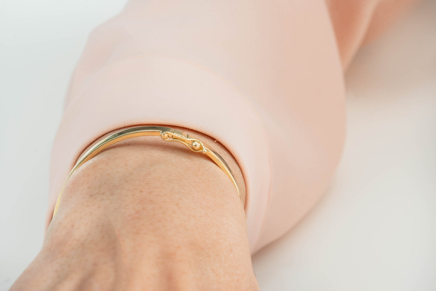 A 3.50mm bangle bracelet in 14k gold, designed for women.