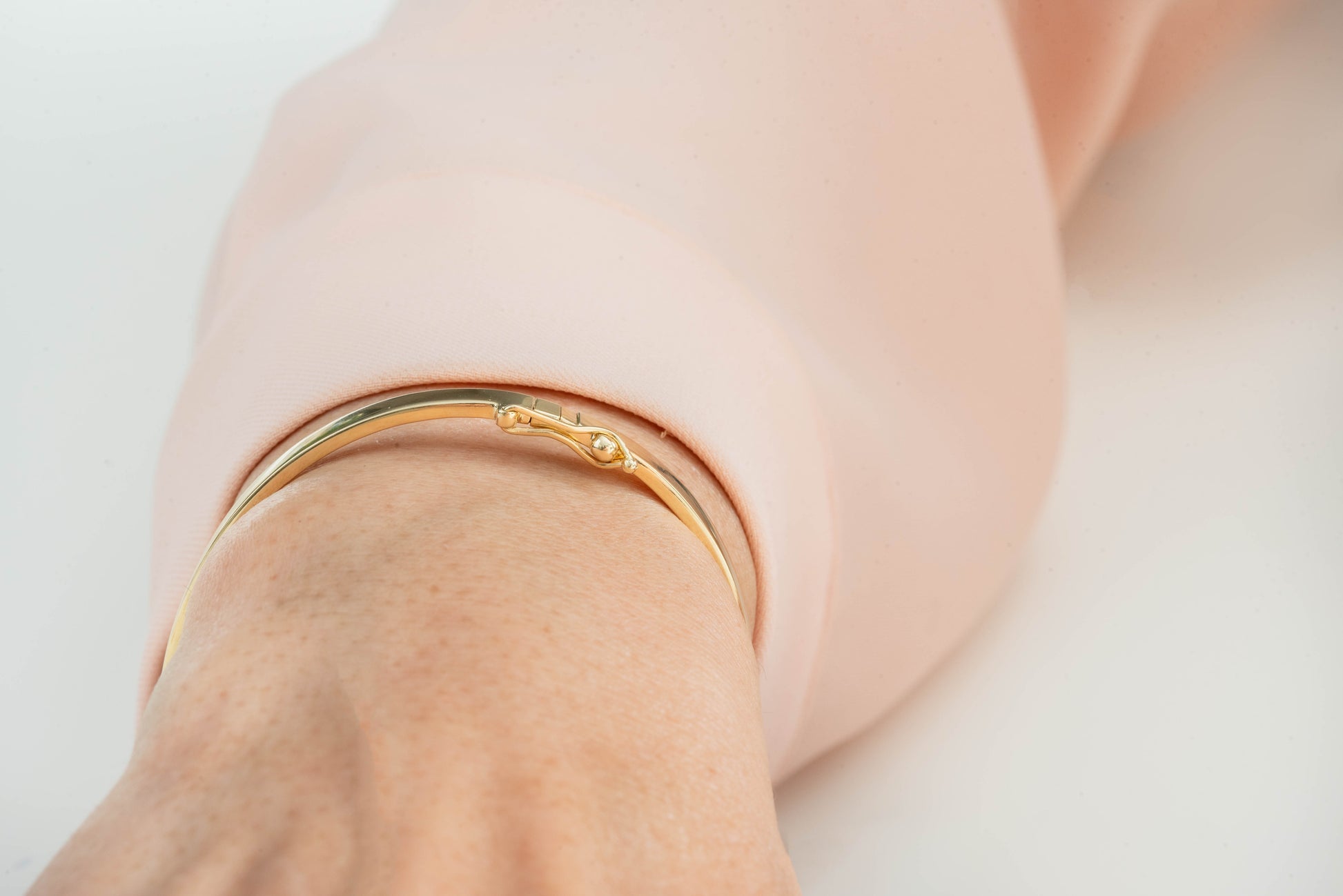 A 3.50mm bangle bracelet in 14k gold, designed for women.