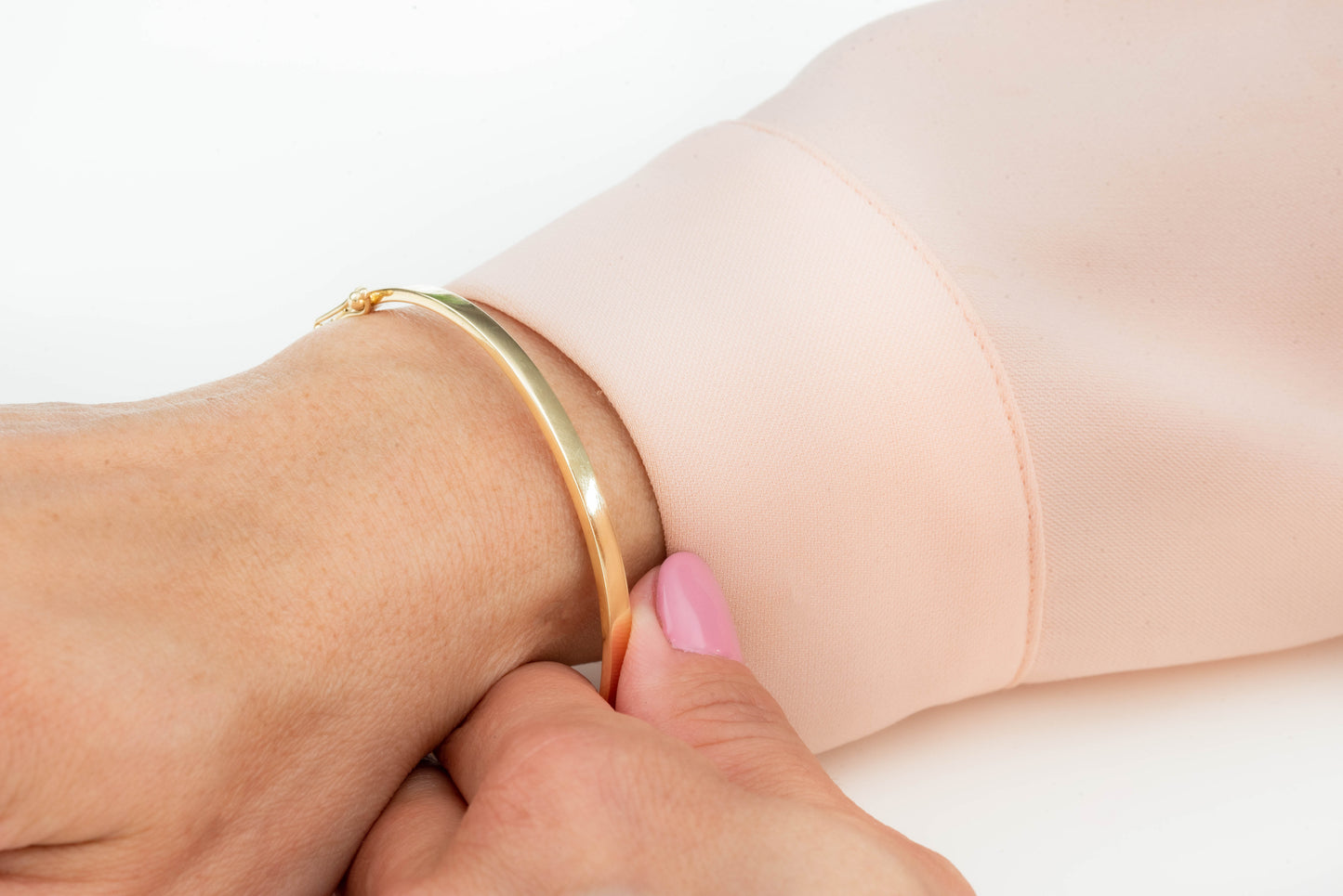 A 3.50mm bangle bracelet in 14k gold, designed for women.