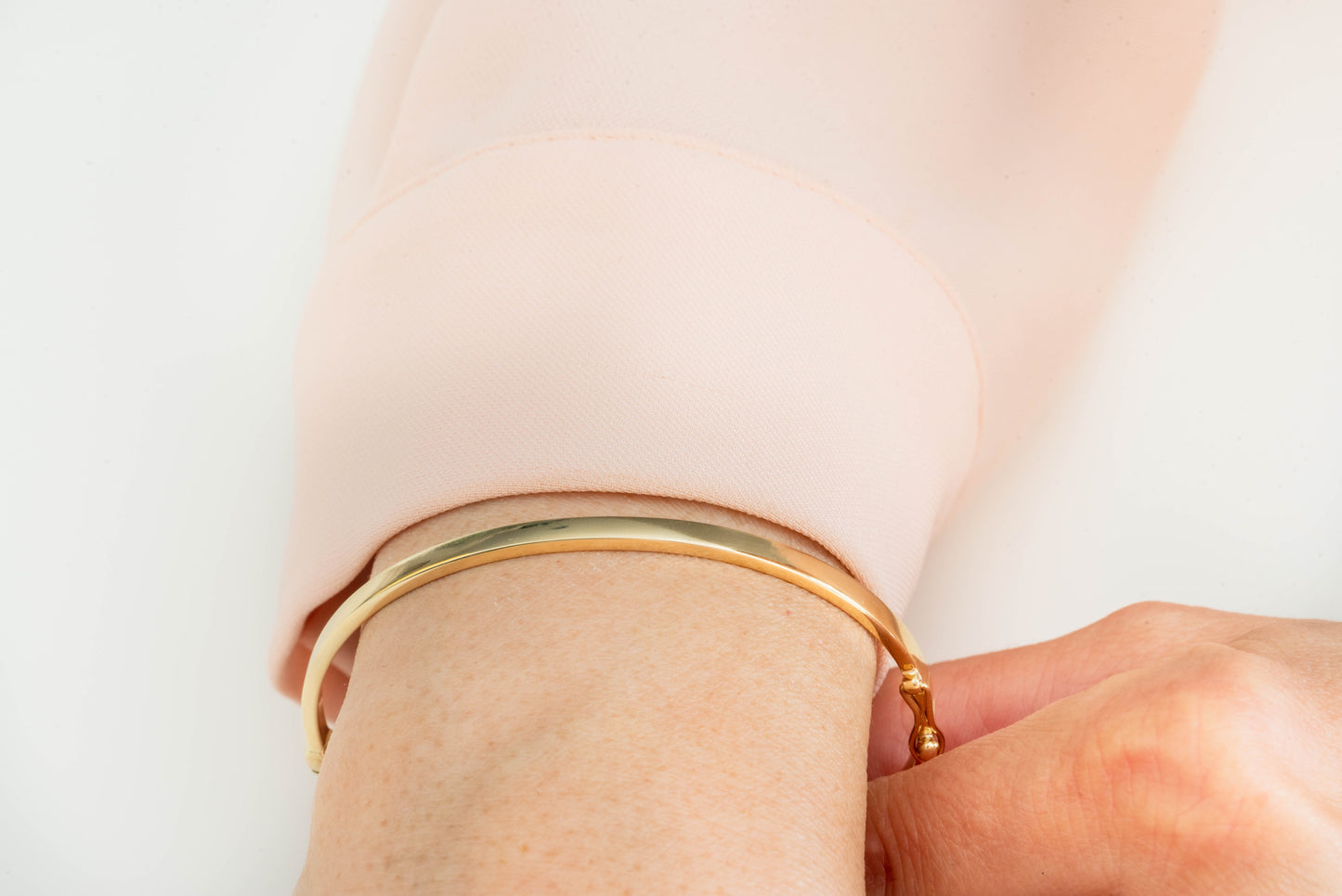 A 3.50mm bangle bracelet in 14k gold, designed for women.