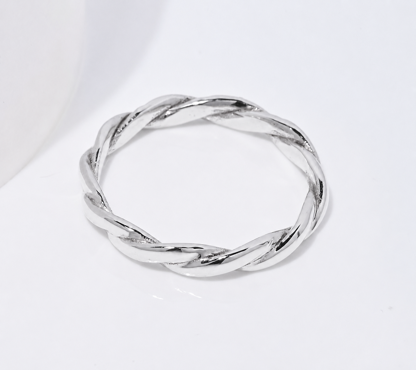14K white Gold twisted ring on a white background
