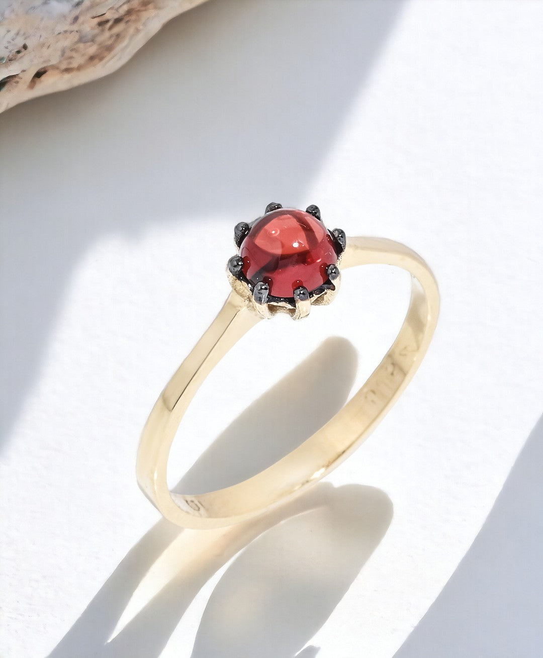 A natural garnet ring set in a 14k solid gold prong setting, designed for women.