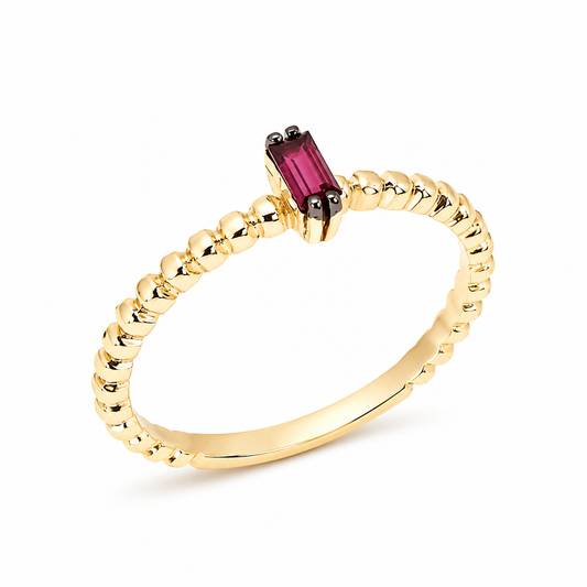 14k gold beaded ring with a baguette-cut ruby gemstone in a delicate four-prong setting on a polished beaded band