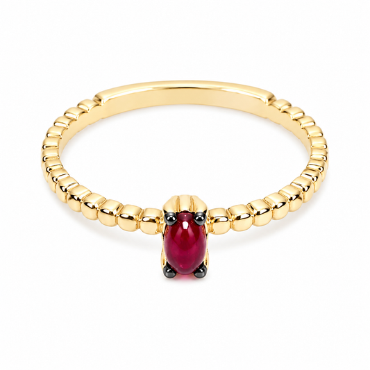 14k Gold beaded ring with ruby on a white background