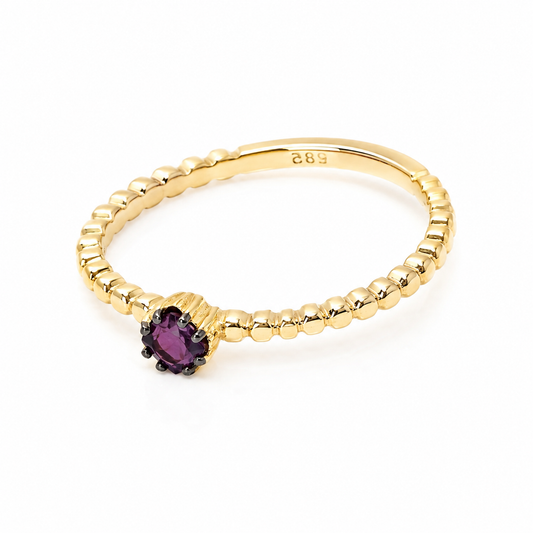 14k Gold ring with a ruby gemstone on a white background