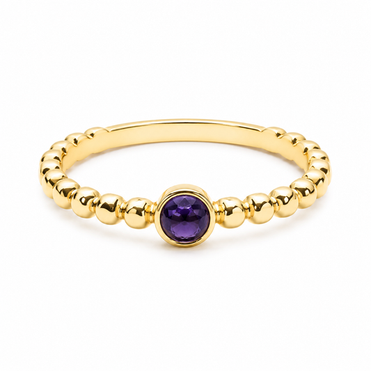 14k Gold beaded ring with a sapphire gemstone on a white background