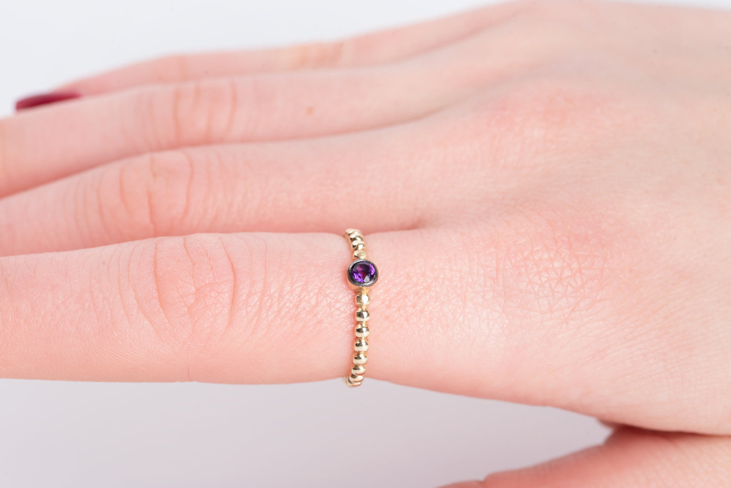 Handmade beaded ring featuring a single birthstone in a bezel setting.