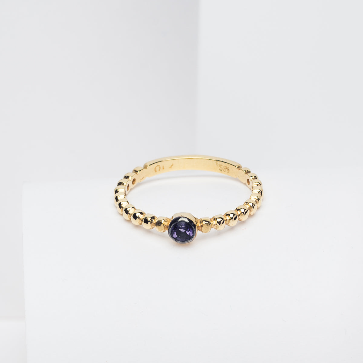 Handmade beaded ring featuring a single birthstone in a bezel setting.