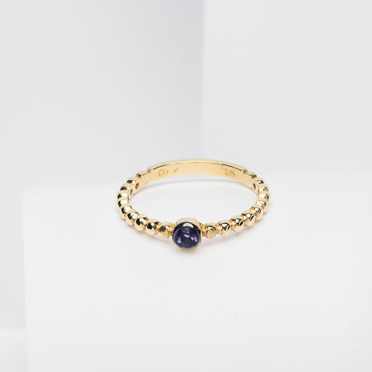 Handmade beaded ring featuring a single birthstone in a bezel setting.