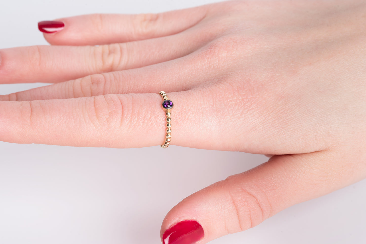 Handmade beaded ring featuring a single birthstone in a bezel setting.