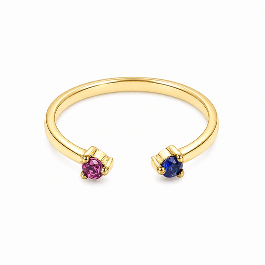 14k Gold ring with a pink ruby and blue sapphire gemstone on a white background