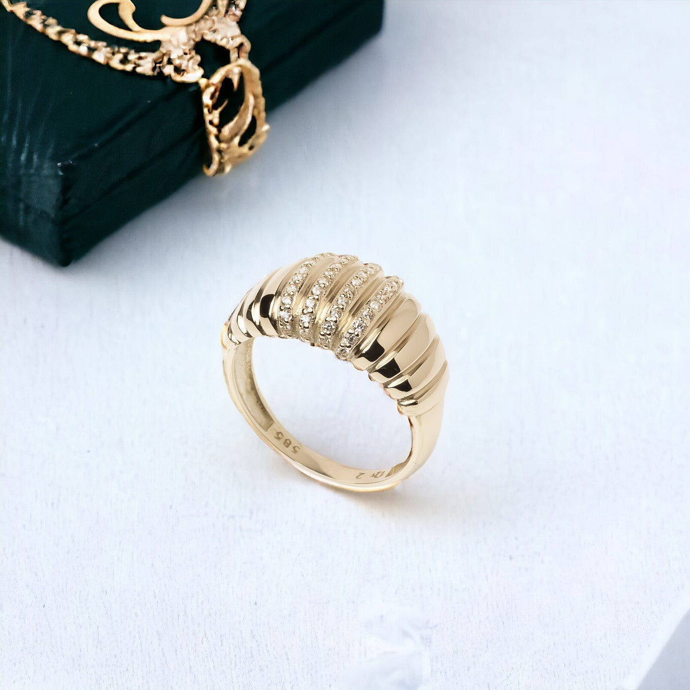 A Croissant Ring adorned with white cubic zirconia stones, set in 14k gold for women.