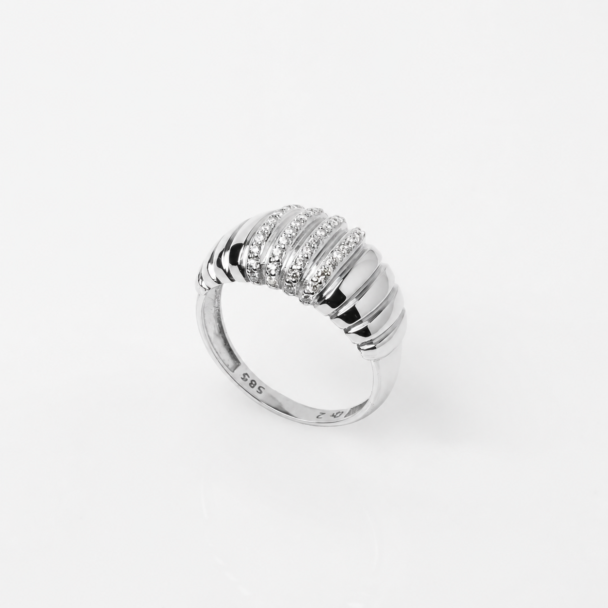 Ribbed dome ring in 14k white gold with cubic zirconia stones in a white background