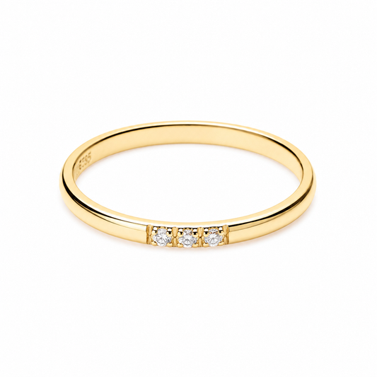 14k Gold ring with three small diamonds on a white background