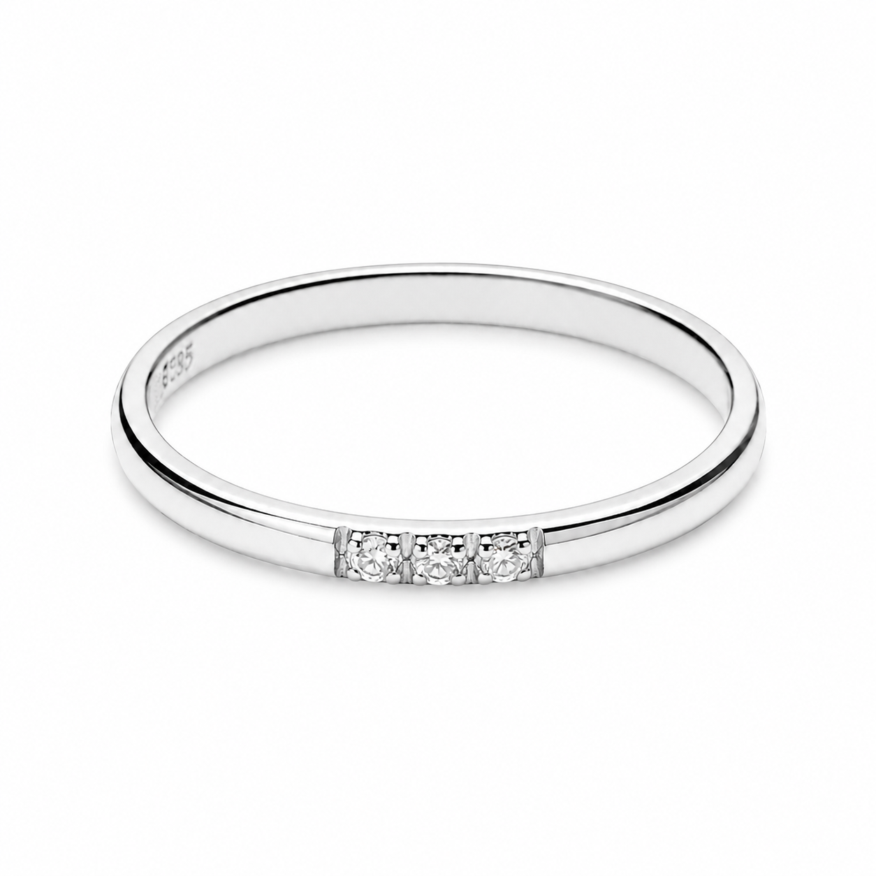 14k white Gold ring with three small diamonds on a white background