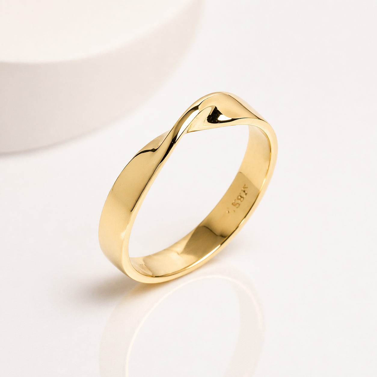 14k solid gold Mobius ring with a polished twisted design on a white background, customizable with personal engraving 
