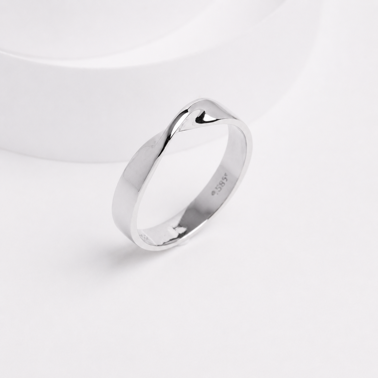 14k solid gold Mobius ring with a polished twisted design on a white background, customizable with personal engraving