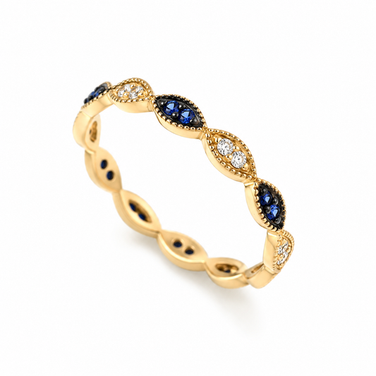 14k Gold ring with blue and clear gemstones on a white background