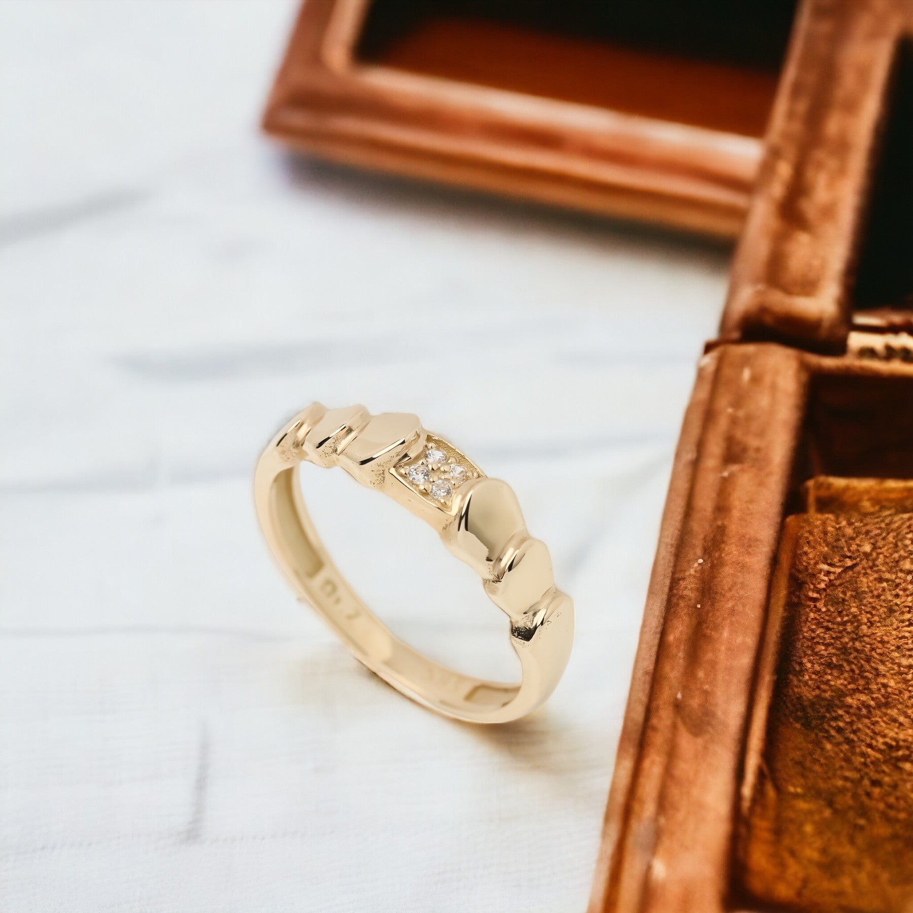 Handmade wrapped ring in 14k solid gold, the top part of the ring is encrusted with white cubic zirconia stones.