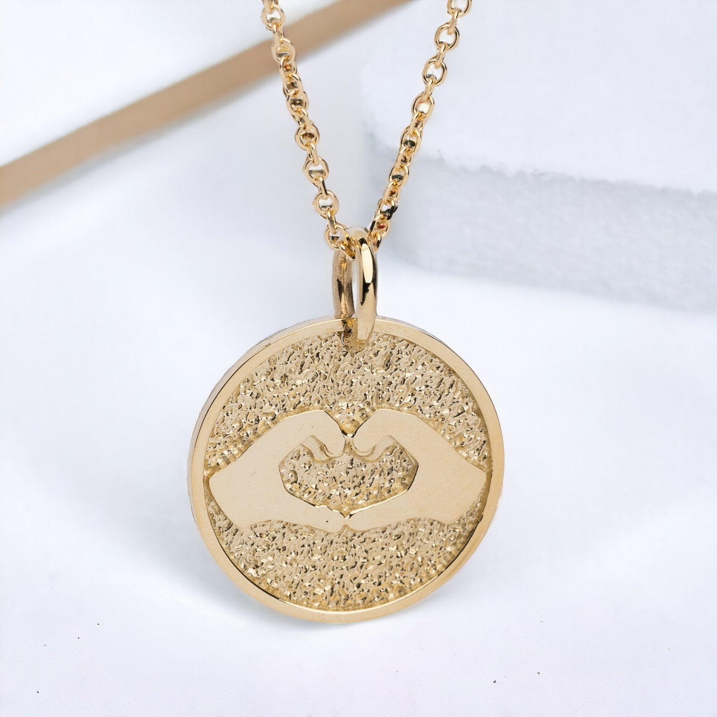 Hand Gesture Heart Necklace in 14k solid gold for women with free engraving on the back side.