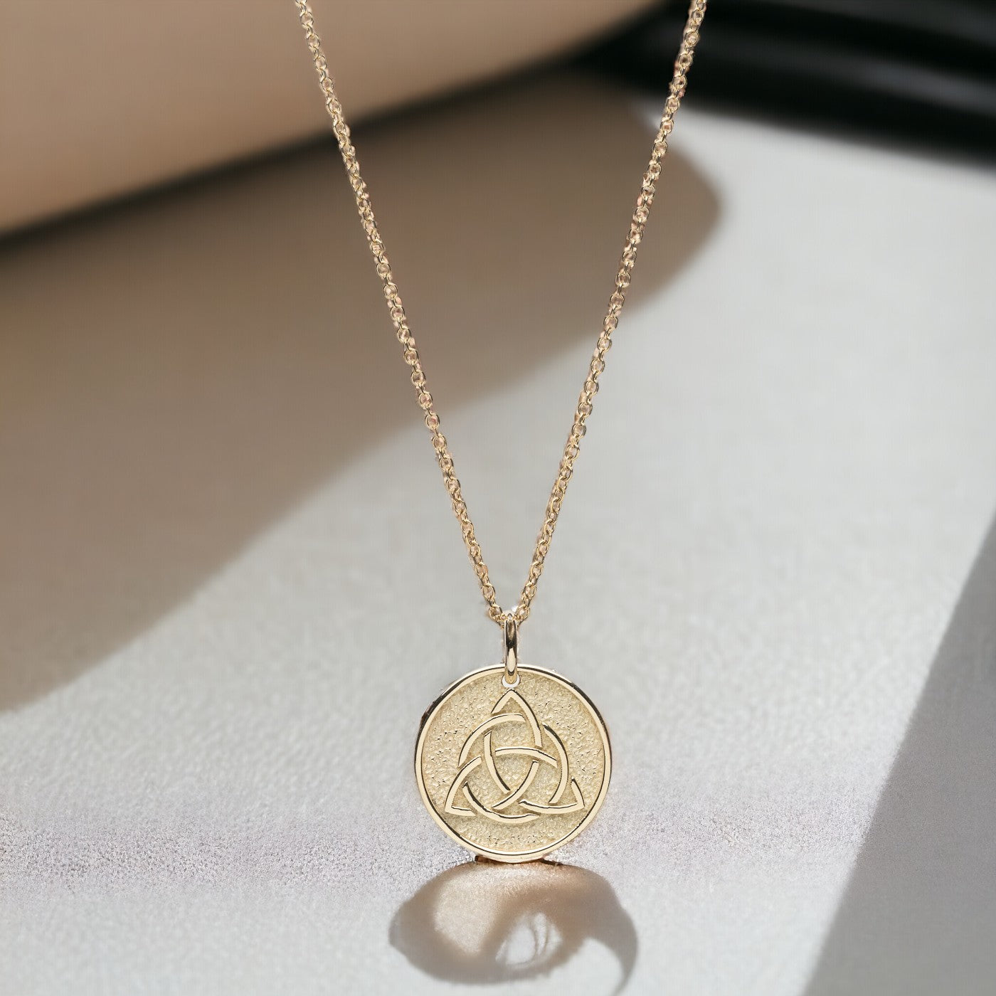 Trinity Knot Necklace in 14k solid gold for women, with complimentary engraving on the reverse side.