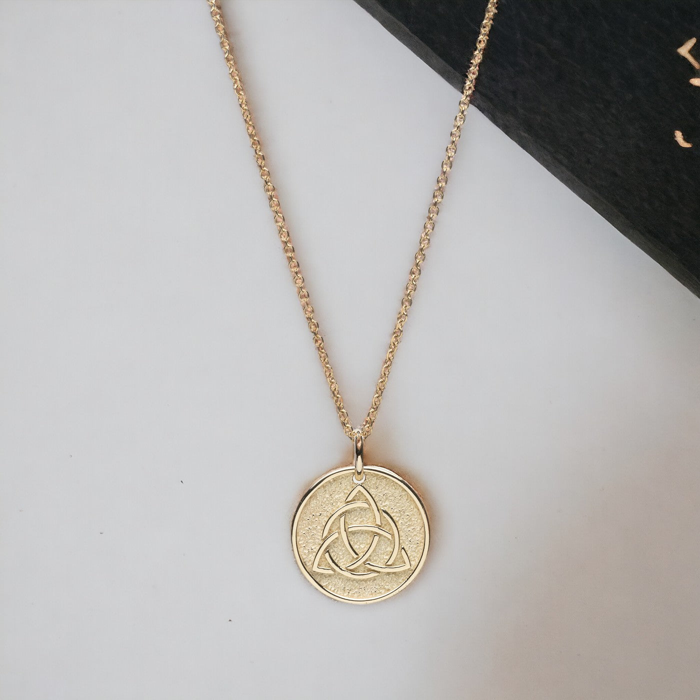 Trinity Knot Necklace in 14k solid gold for women, with complimentary engraving on the reverse side.