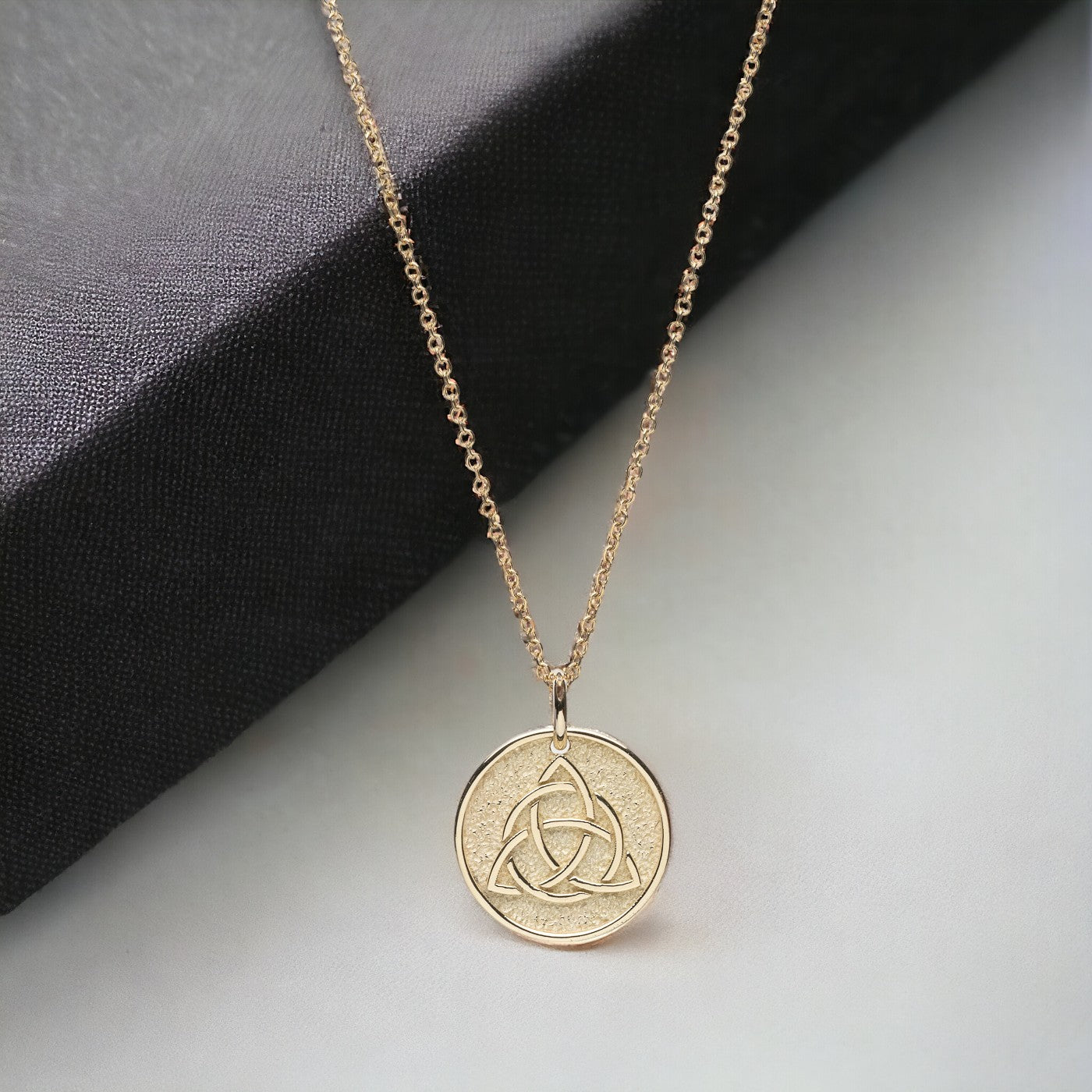 Trinity Knot Necklace in 14k solid gold for women, with complimentary engraving on the reverse side.