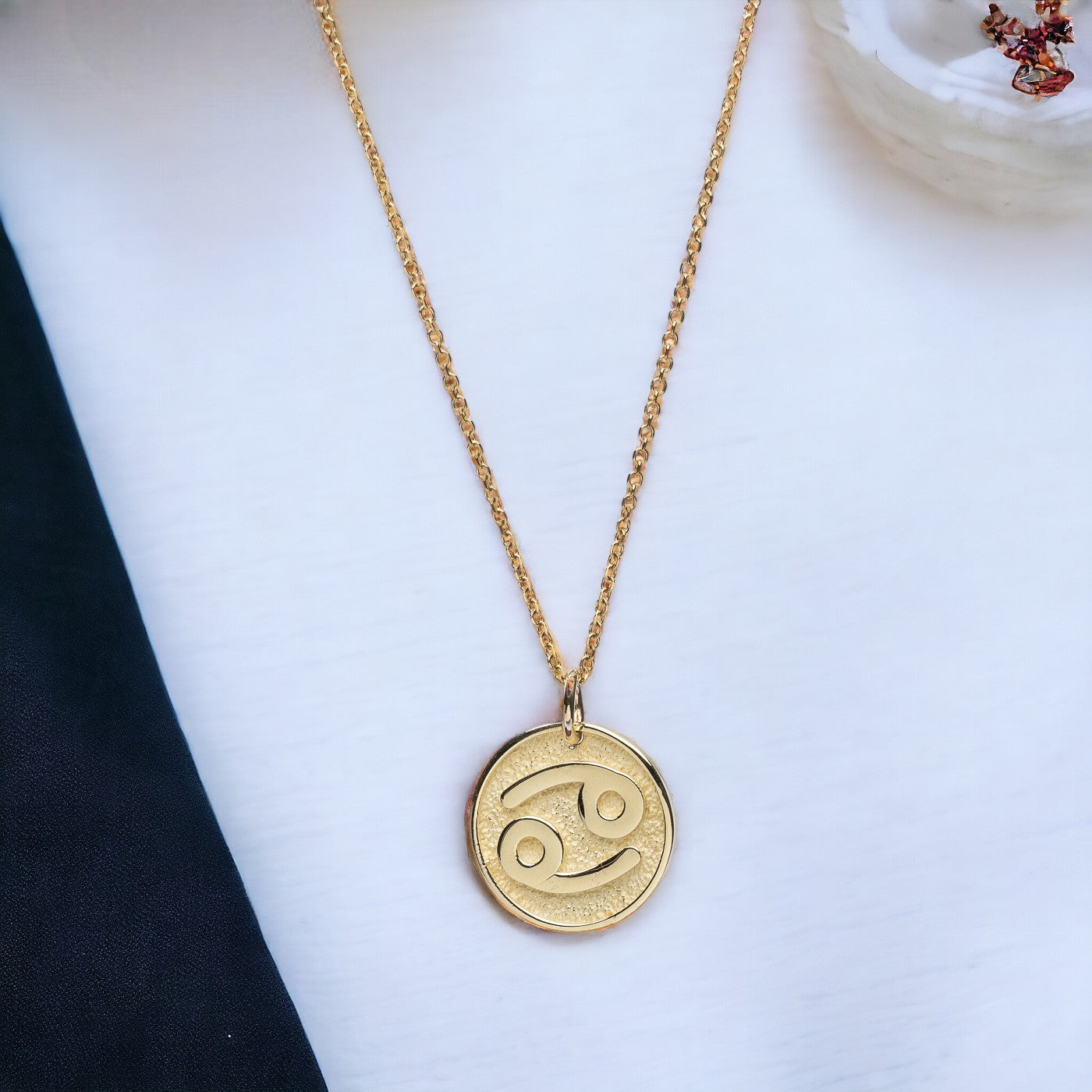 A Zodiac necklace for women, crafted in 14k gold, featuring complimentary engraving on the reverse side.