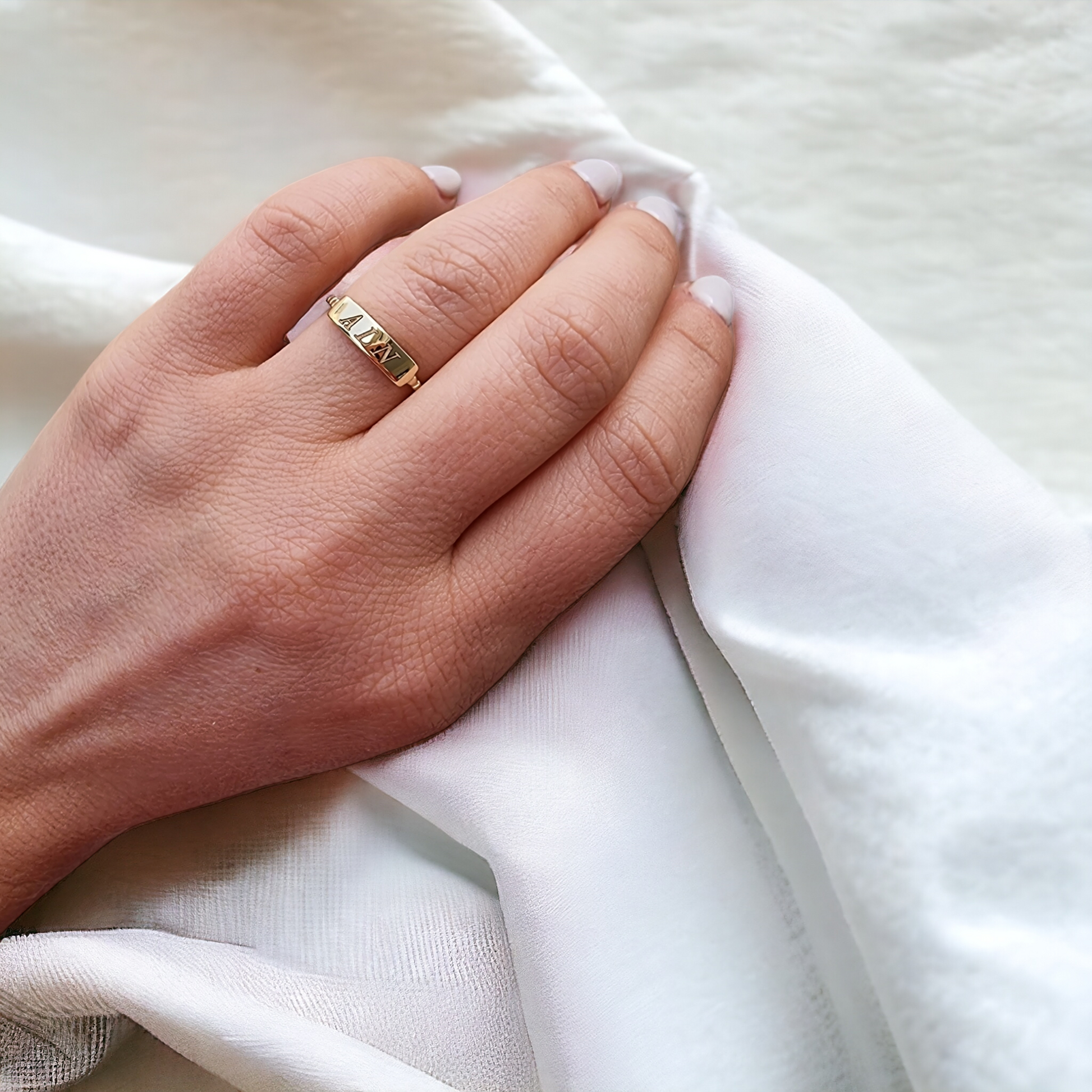 A personalized bar ring for women, crafted in 14k gold and featuring a beaded design.