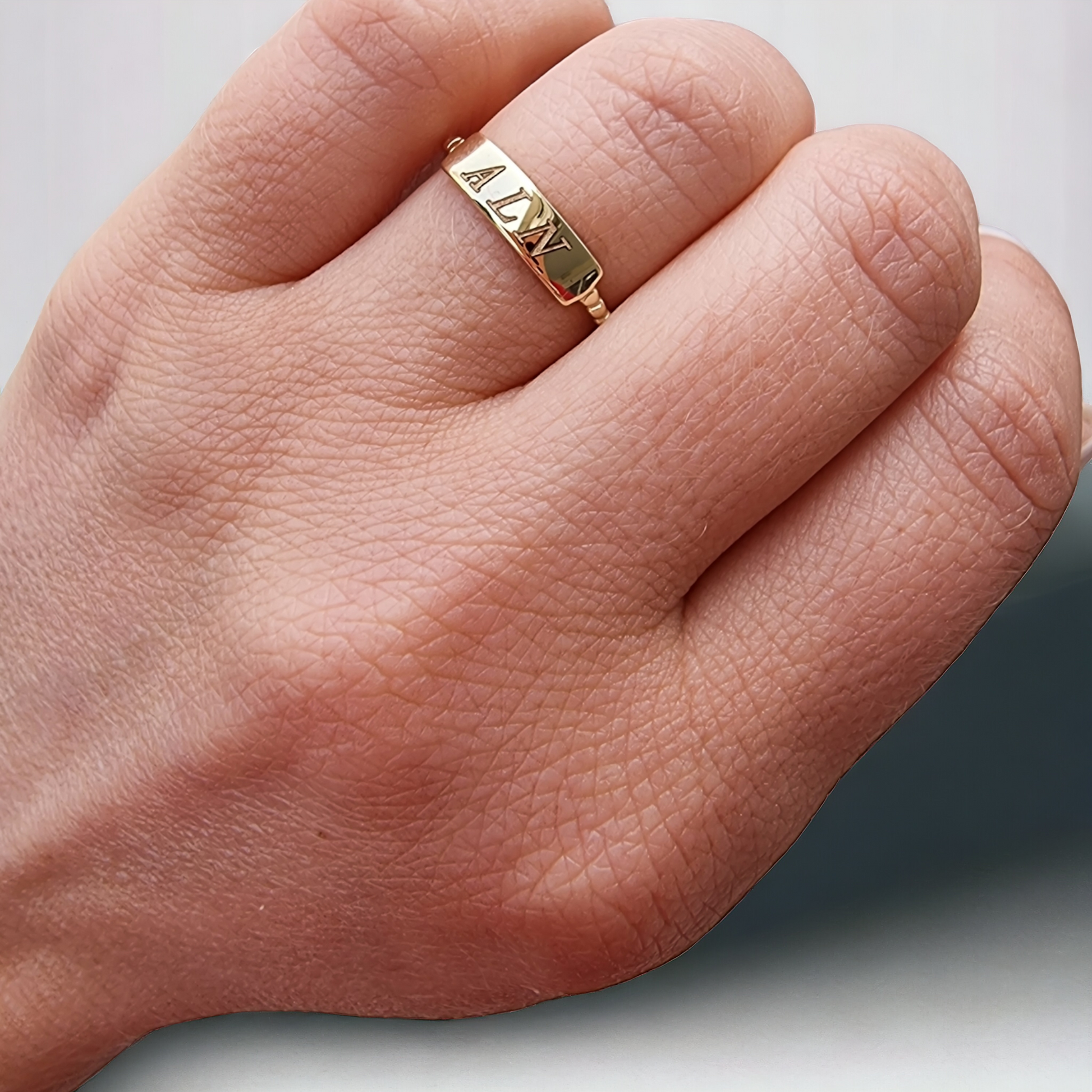 A personalized bar ring for women, crafted in 14k gold and featuring a beaded design.