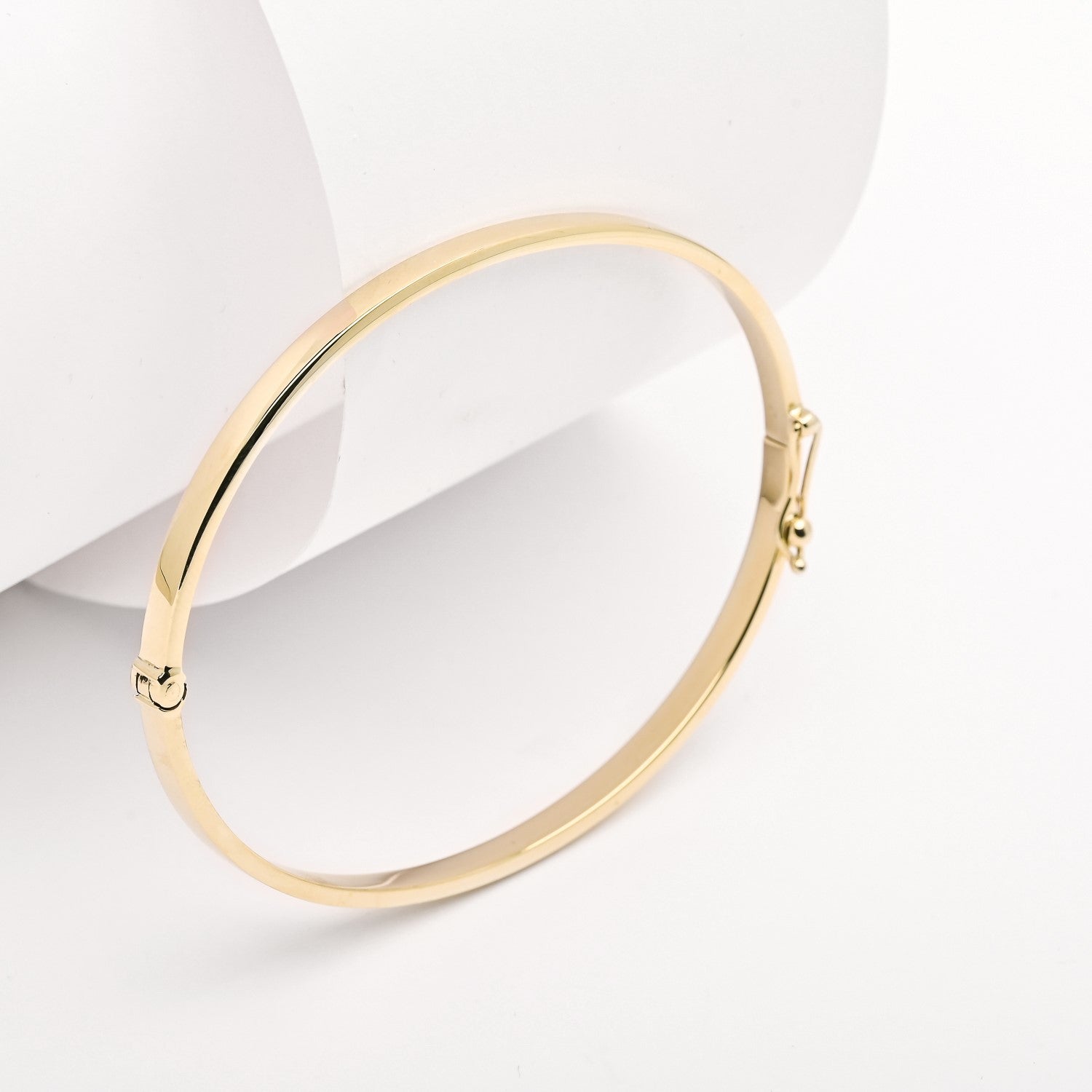 A 3.50mm bangle bracelet crafted in 14k yellow gold for women.