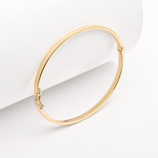 A 3.50mm bangle bracelet crafted in 14k yellow gold for women.