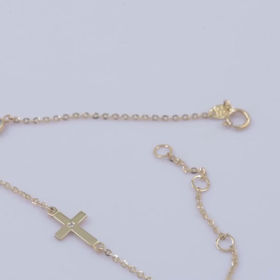 diamond cross and evil eye bracelet in 14k yellow gold