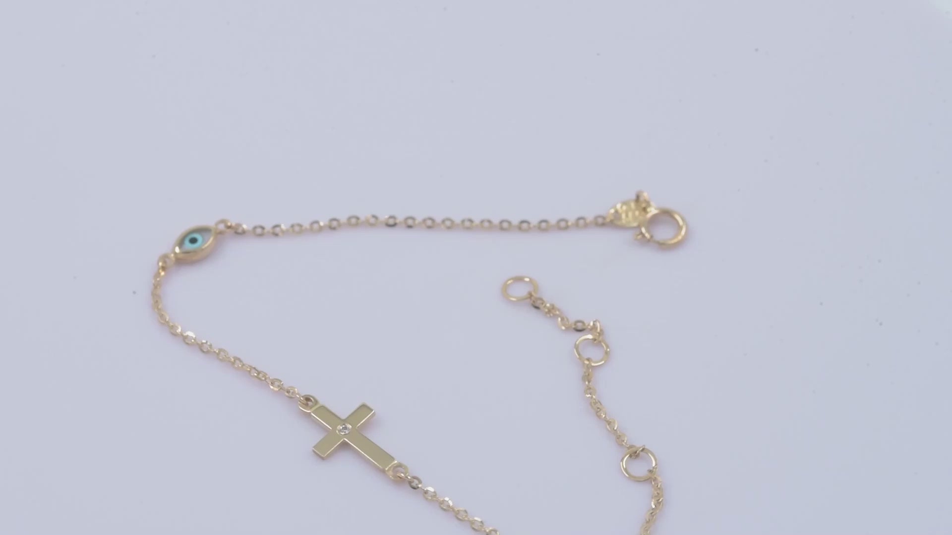 diamond cross and evil eye bracelet in 14k yellow gold