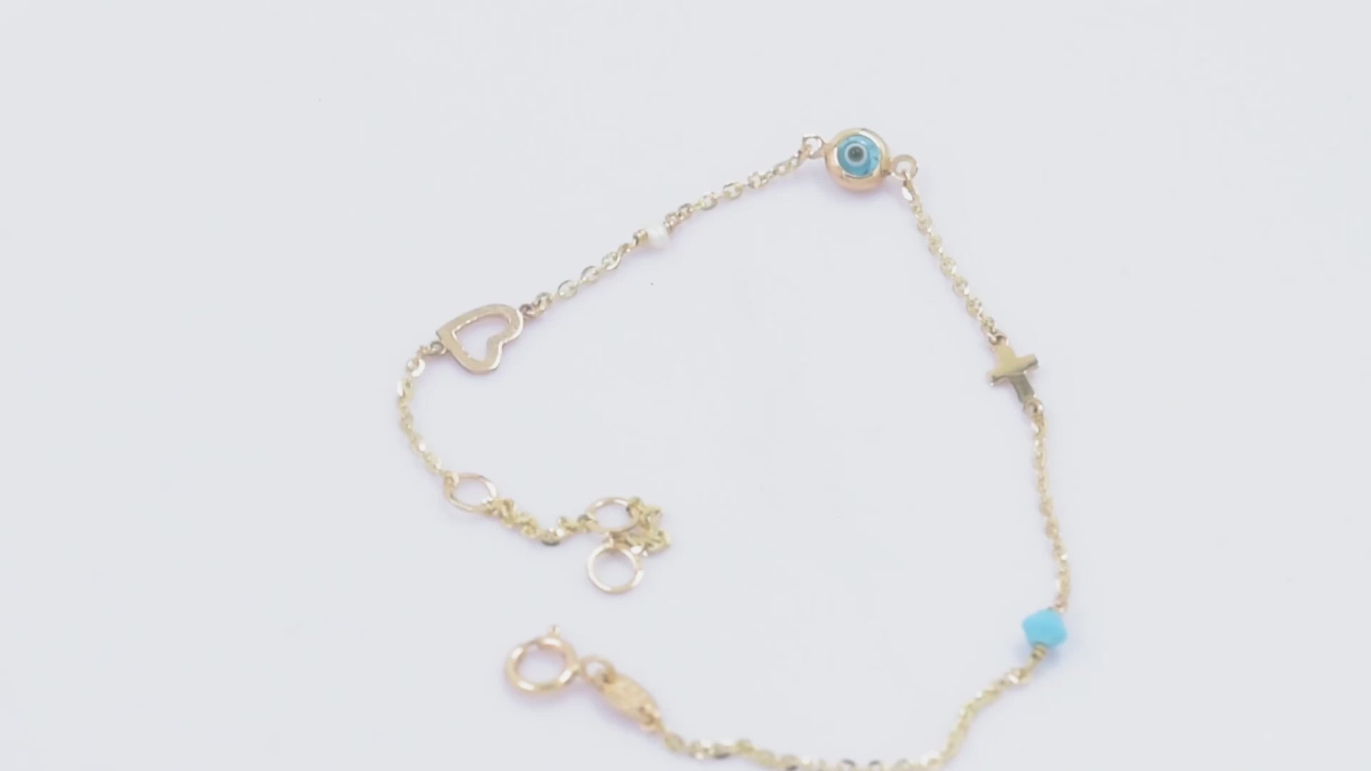 evil eye bracelet with cross, heart, pearl, turqoise stone in 14k solid gold