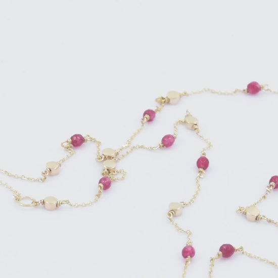 Station necklace featuring gold beads and tourmaline stones set in 14k gold.