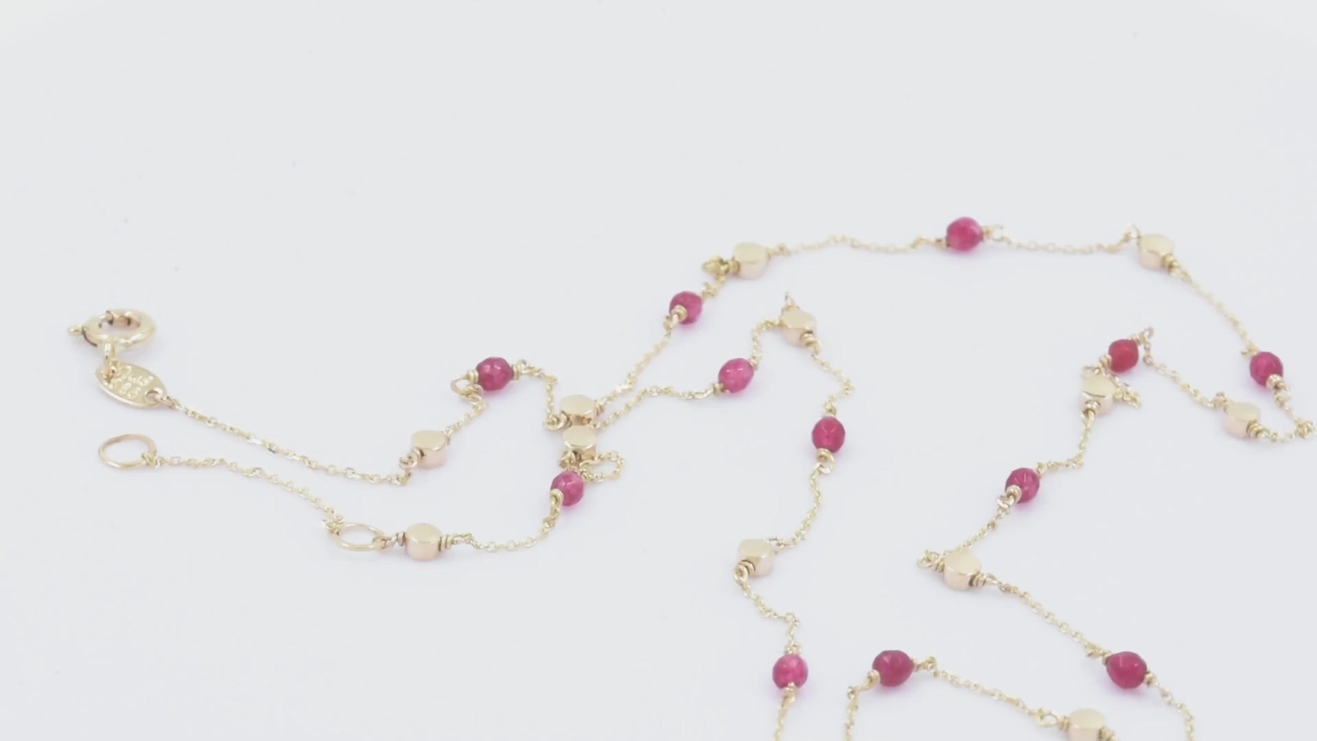 Station necklace featuring gold beads and tourmaline stones set in 14k gold.